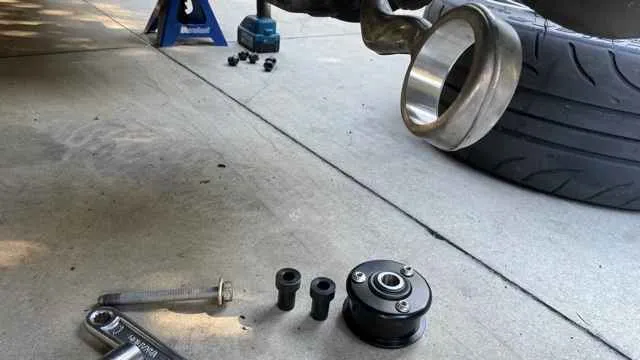 Mechanic using a press for bushing installation