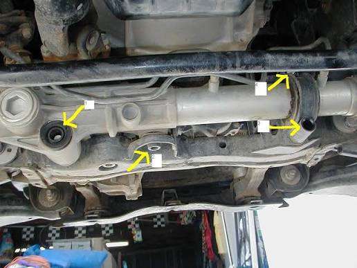Location diagram showing external steering rack mounting bushings between the rack housing and subframe, separate from the internal rack guide bushing